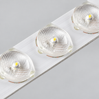 Original macro photograph of three LED lenses in the ceiling light