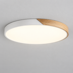 Flush ceiling light with white rim, wood segment and round white diffuser