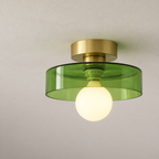 Semi flush ceiling light with gold fitting and transparent green glass shade